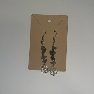 Green and purple handmade gemstone earrings with a clover charm at the bottom
